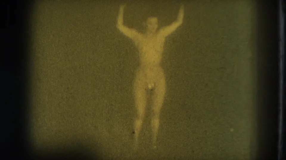 Warmer yellow-green 8mm frame from the 1975 San Francisco metadata showing the adult dancer upright with arms lifted.