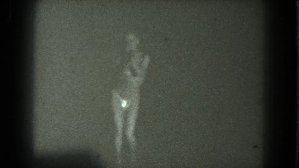 1975 8mm San Francisco footage appears to show a blurred minimally clothed dancer facing the camera in a dim room.