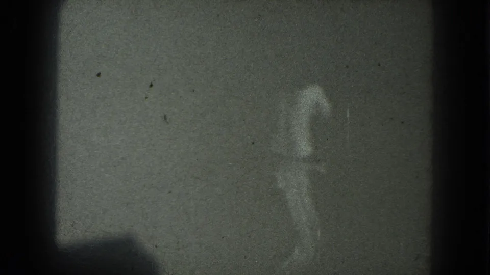 The final frame shows the dancer faintly at the right side of a dark 1975 8mm club scene, with subdued exposure and visible film wear.