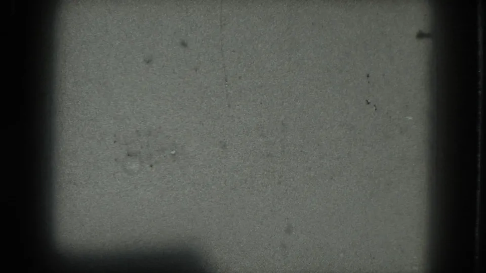 A faint female performer appears as a pale blurred shape in a dark 1975 San Francisco 8mm frame.