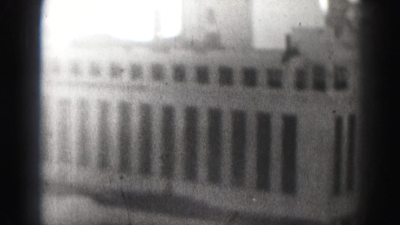 Soft black-and-white Harrisburg city view from 1975, with an office building facade and visible film wear.