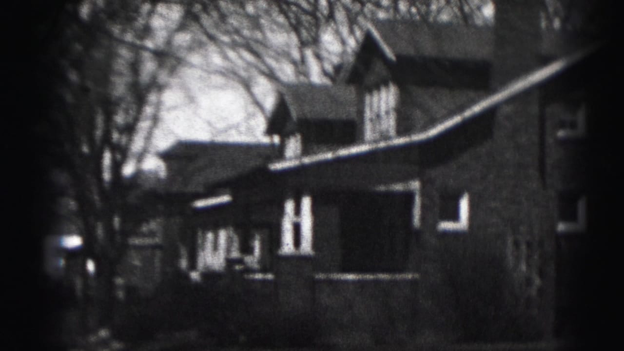 Harrisburg 1975 8mm view of a brick residential building framed by bare trees and soft film edges.