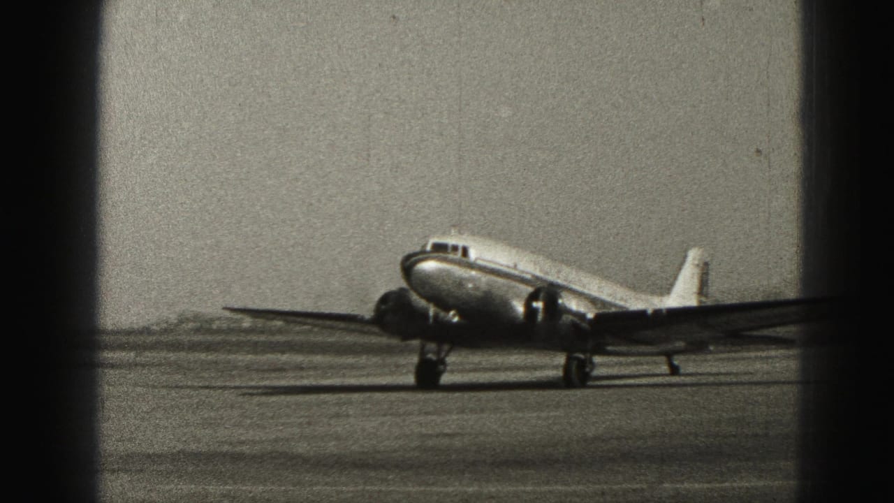 Side view of a small passenger aircraft taxiing at Harrisburg, Pennsylvania, in 1975 archival 8mm footage.