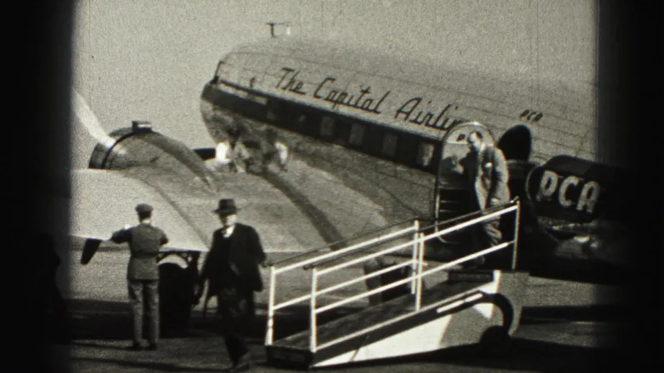 Passengers and ground crew appear beside the open door of a Capital Airlines plane at Harrisburg, Pennsylvania.