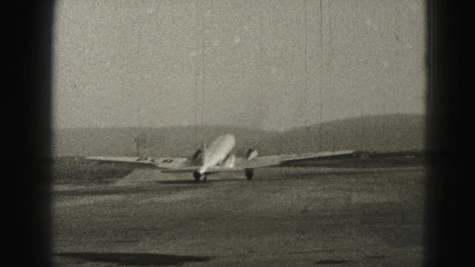 Rear view of the aircraft taxiing at Harrisburg, Pennsylvania, with its wings spread across the frame and runway pavement below.