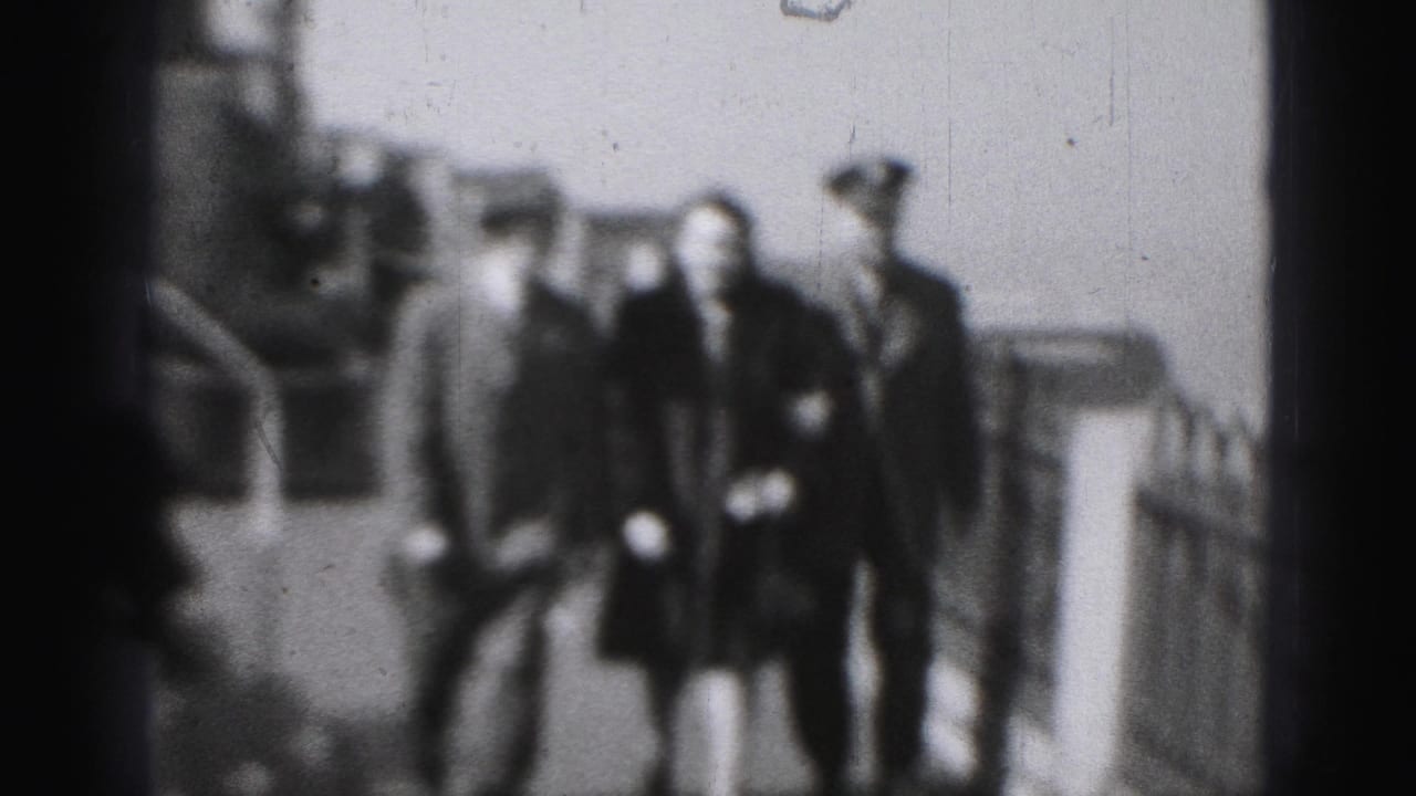 The trio approaches on the deck, with the woman centered between two hat-wearing men and ship railings visible in the background.