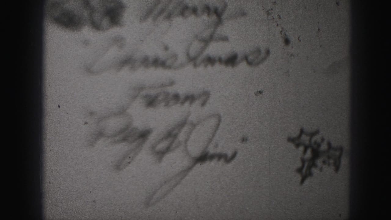 Second view of the handwritten note with signatures and dark frame borders.