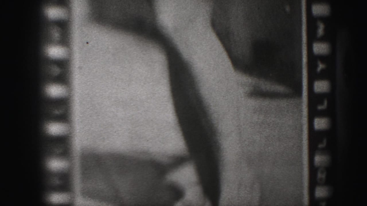 Close black-and-white poster detail with legs, feet, and partial printed lettering near the bottom.