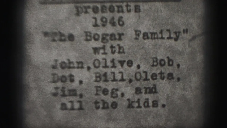 Monochrome 1946 home-movie title card for the Bogar family, framed by dark 8mm gate edges and soft focus.