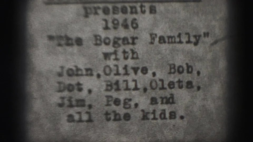 Soft, grainy 8mm frame showing the 1946 Bogar family title card and a list of relatives' first names.