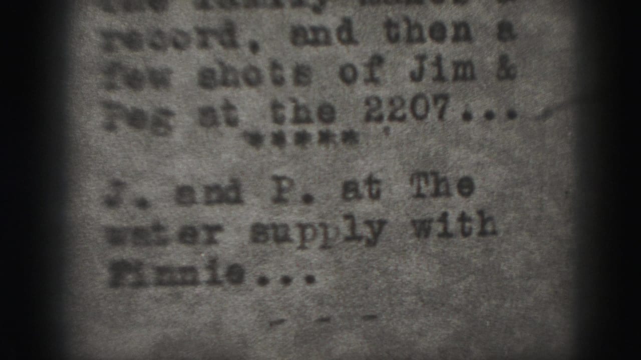 Blurred typed paper close-up with partial names and dark edge shadows.