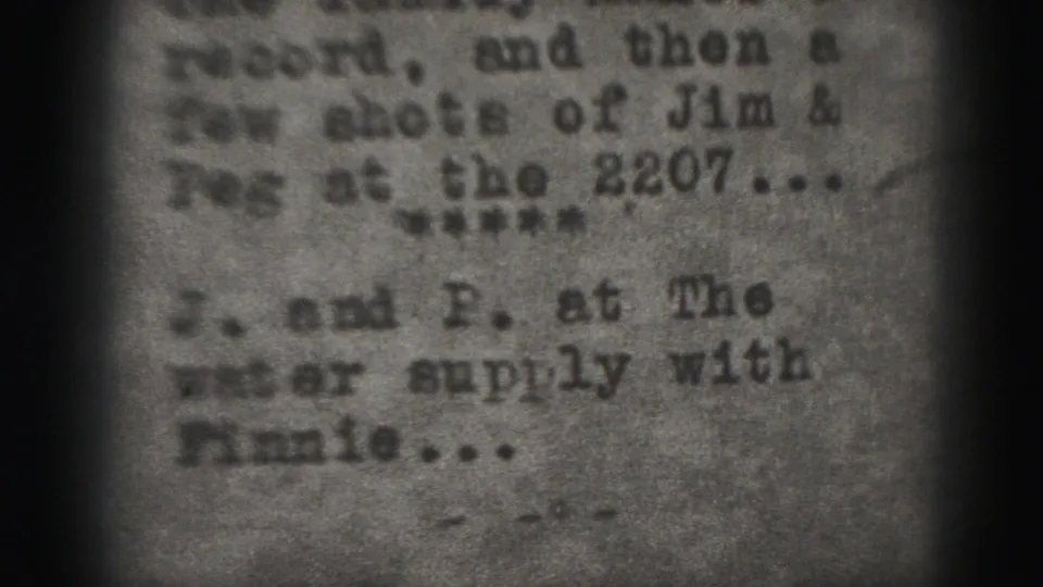 Harrisburg 1975 8mm frame showing repeated typed family-note text in soft focus.