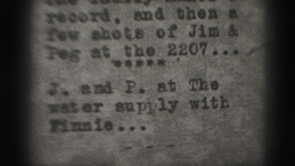 1975 Harrisburg home-movie frame with blurred typewritten intertitle text, visible grain, and dark 8mm frame edges.