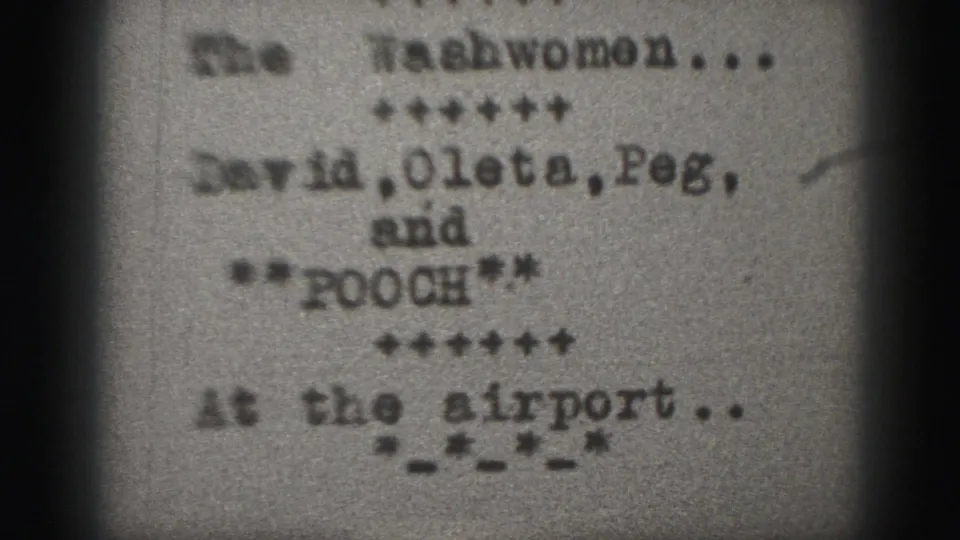 Grainy 1975 Harrisburg 8mm intertitle showing The Washwomen, listed names, Pooch, and At the airport text.