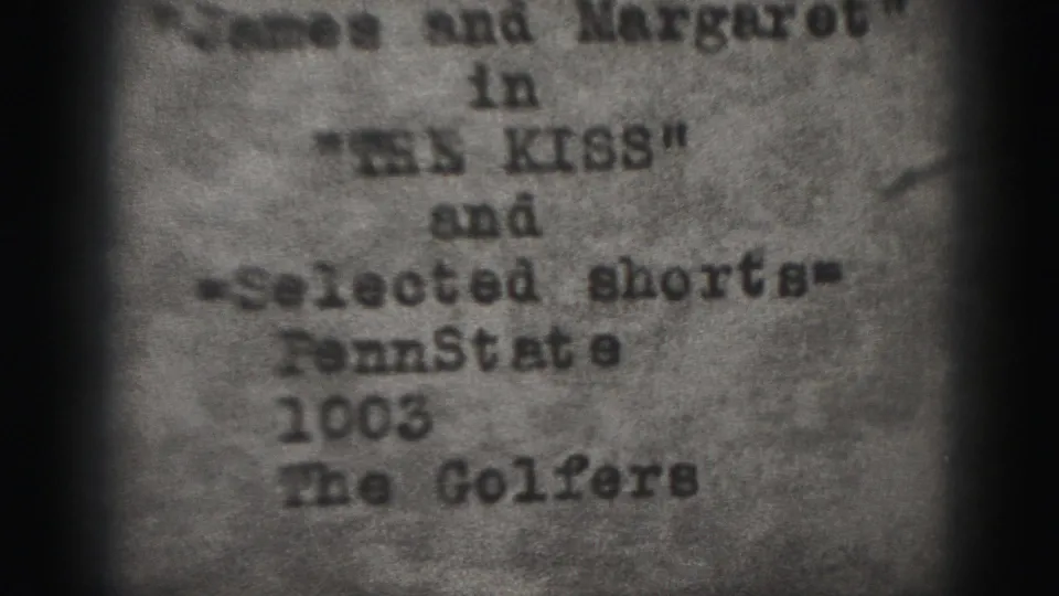 Soft, grainy 8mm frame from the 1975 Harrisburg reel showing typed references to The Kiss, selected shorts, Penn State 1003, and The Golfers.