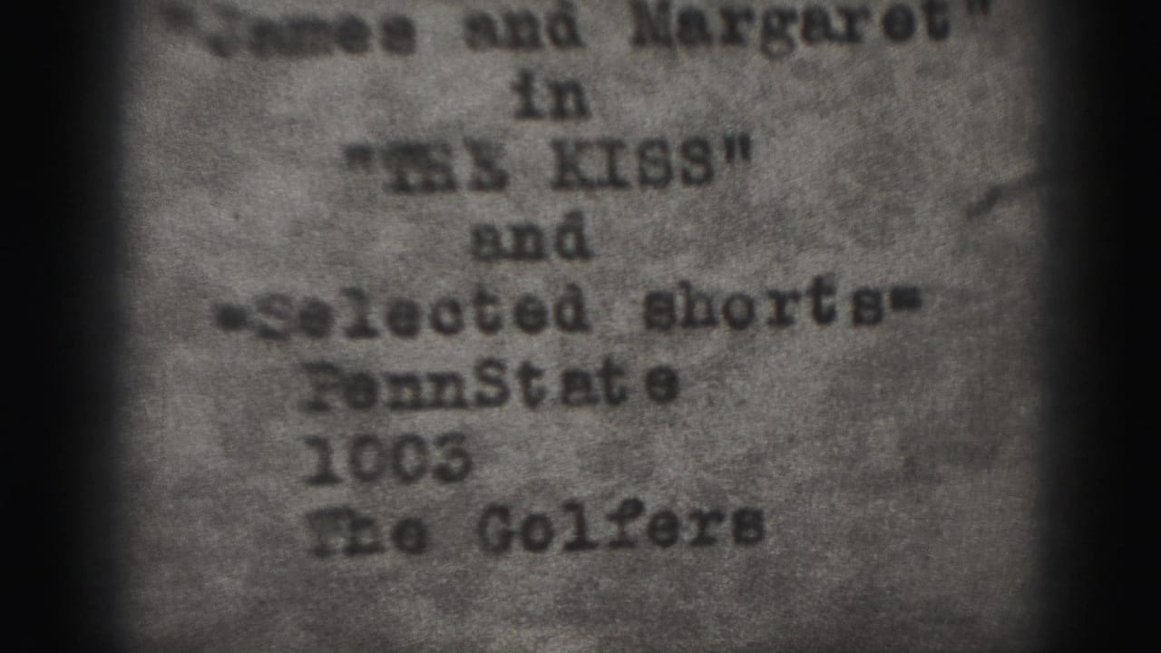Soft-focus typewritten credit card with partial titles and names visible inside dark 8mm frame edges.