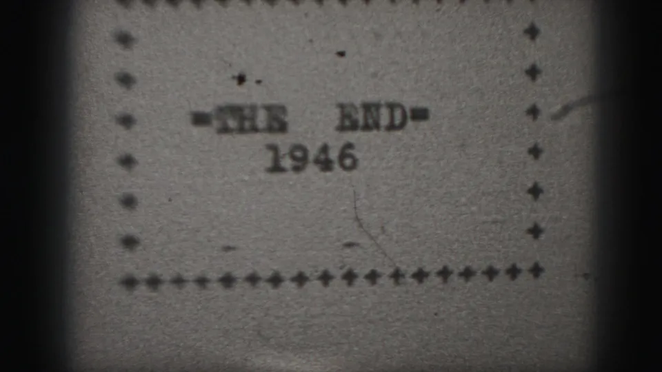 Grainy 8mm scan of the 1946 end title card, with dotted frame, dust, scratches, and uneven monochrome exposure.