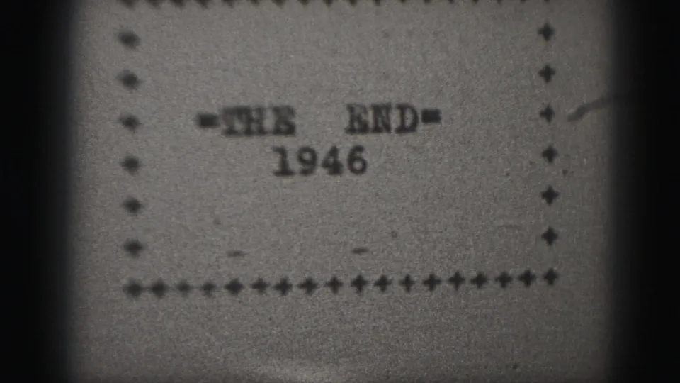 Final 8mm frame showing the 1946 end card, with typed title text, dotted border, visible grain, and darkened edges.