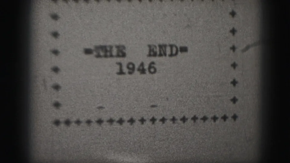 1946 home-movie ending title remains centered, with a dotted border and visible 8mm grain across the frame.