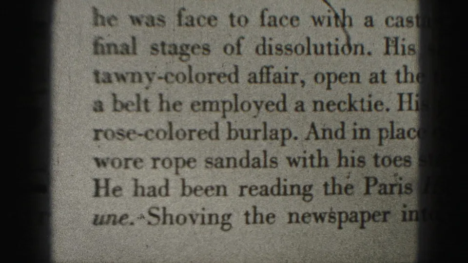 Close-up of printed text mentioning a swim suit and clothing details, cropped tightly within the 8mm home-movie frame.