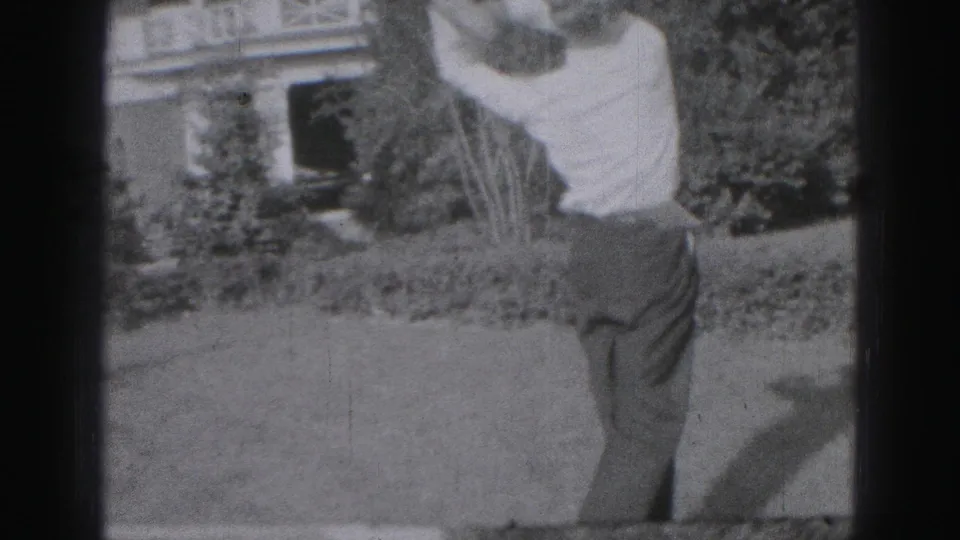 The closing frame shows the man finishing his swing in the Harrisburg yard, with sunlight, lawn, shrubs, and house details visible.