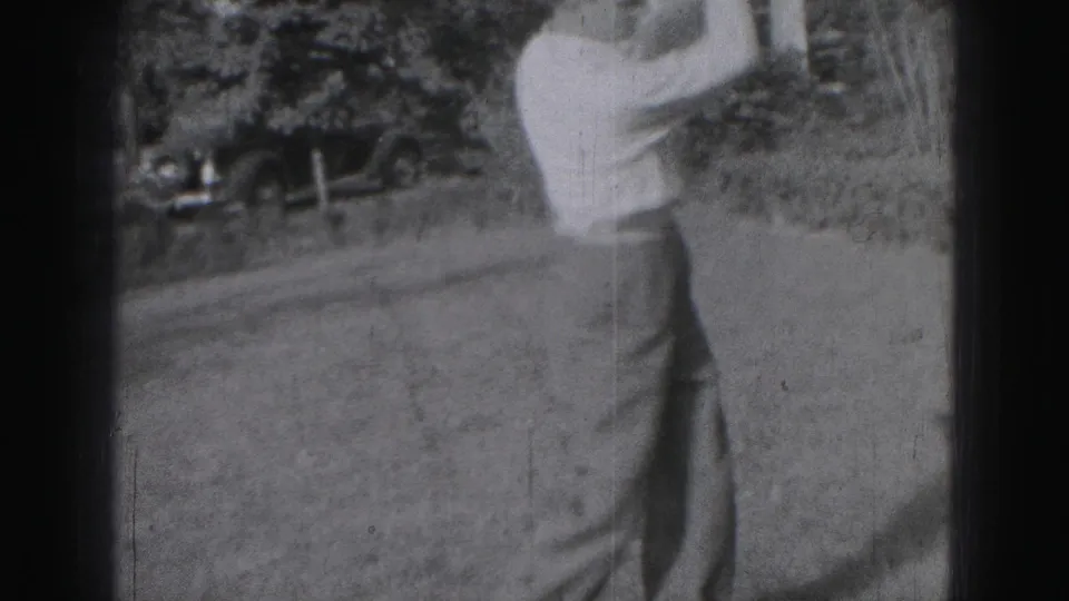 The 1975 Harrisburg home-movie frame shows the golfer partly cropped as he follows through on the grassy area.