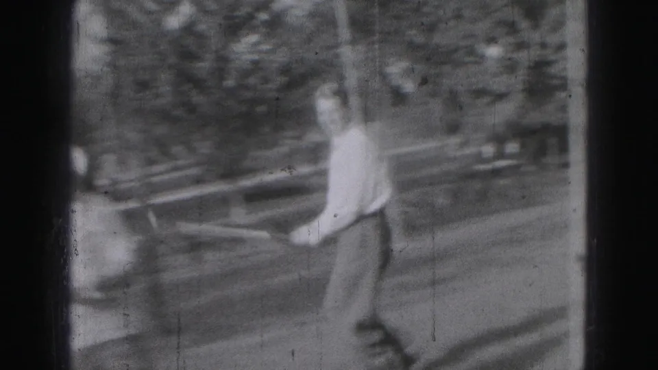 A side view shows the man continuing his golf swing in the yard, with trees and road behind him.