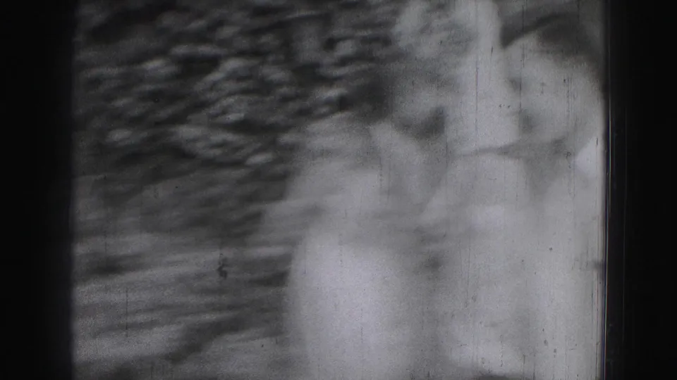 A blurred 8mm frame shows the group and leafy background shifting during handheld movement in the 1975 outdoor scene.