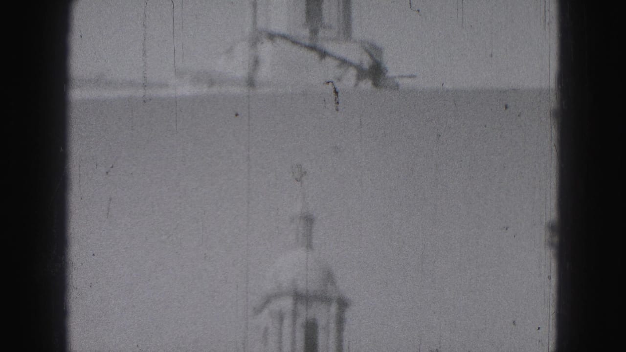Soft 1975 8mm view in Harrisburg showing a tall tower rising above a columned civic-looking building.