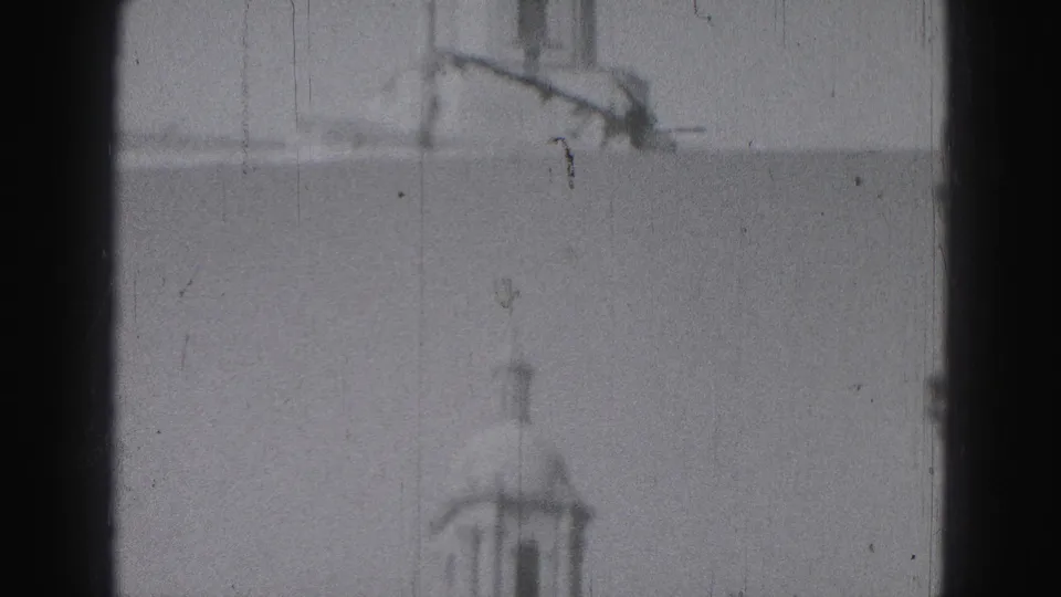 Soft 1975 8mm view in Harrisburg showing a tall tower rising above a columned civic-looking building.