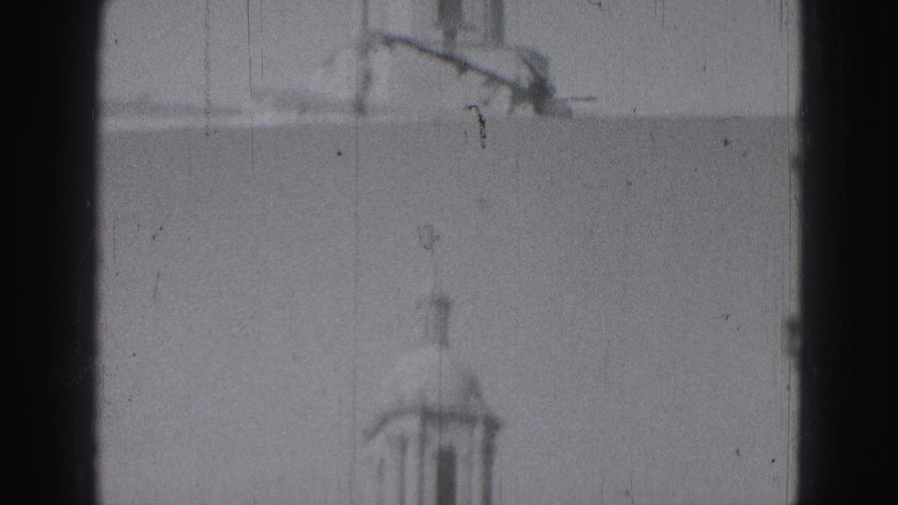 Blurred 8mm frame of the upper tower area and pale facade, with Harrisburg location supported by clip metadata.