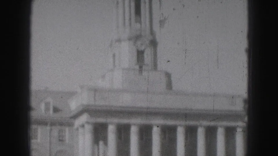 Harrisburg landmark building seen in soft 8mm focus, with columns, roofline, and a tower centered in frame.