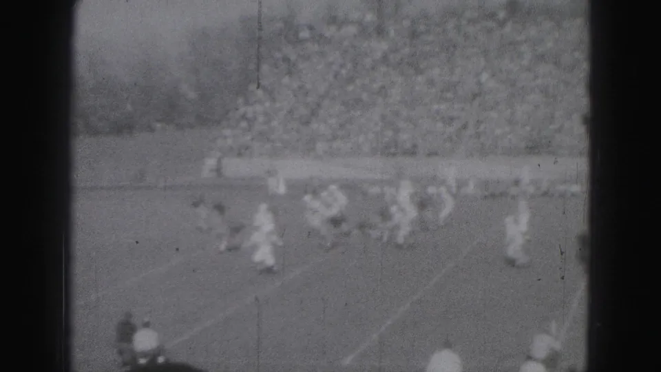 Players appear to converge during a 1975 soccer match in Harrisburg, filmed from a distant spectator position on 8mm.