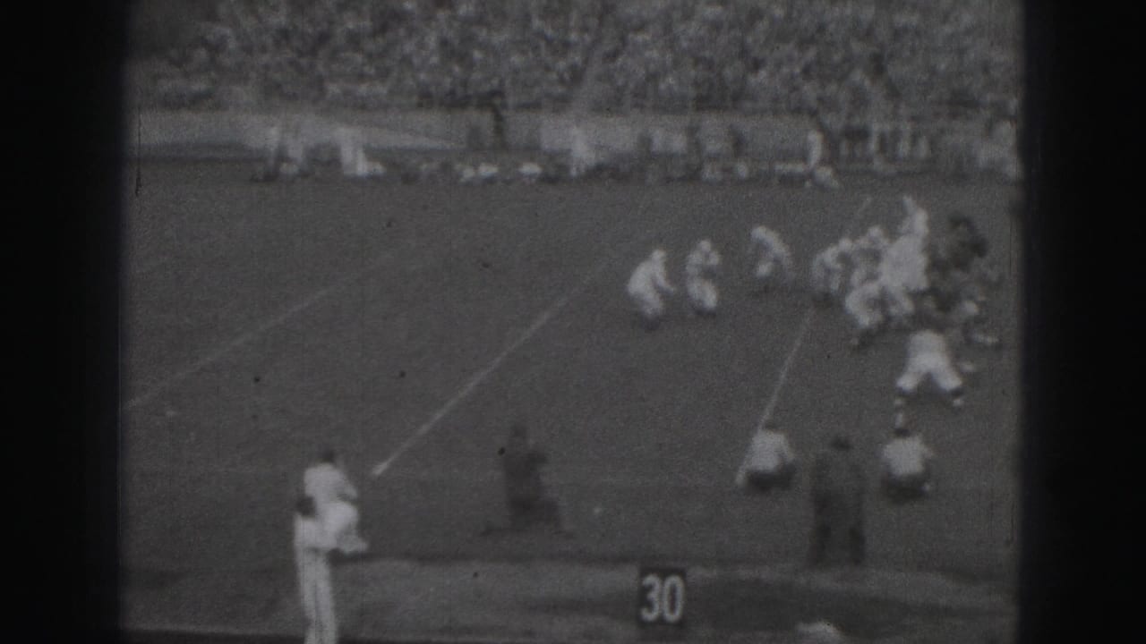 1975 Harrisburg home-movie view of a football play near the 30-yard line, seen from high in the stadium stands.