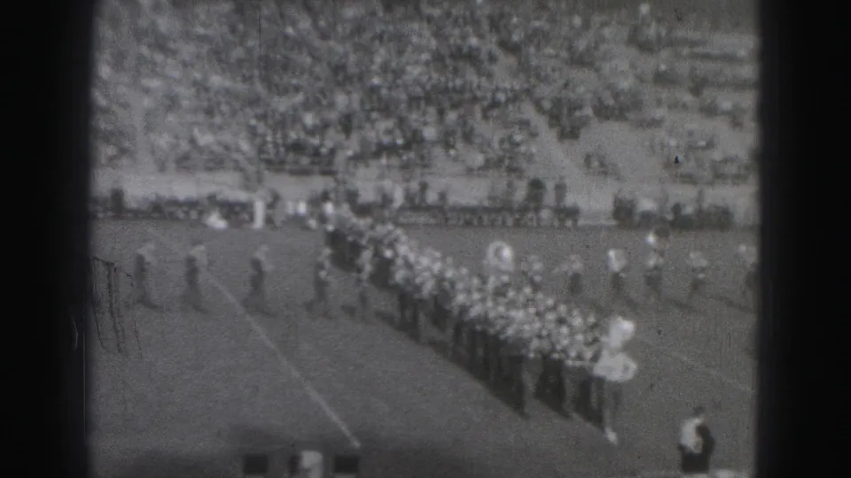 High school marching band in formation on a Harrisburg football field in 1975 home-movie footage.