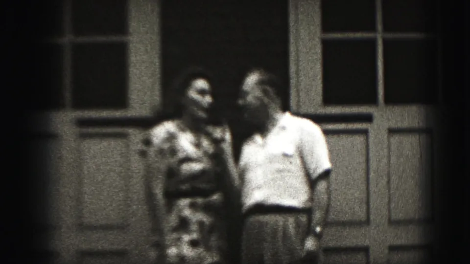 The man and woman stand close together at the end of the 1975 Harrisburg porch scene, with the microphone no longer prominent.