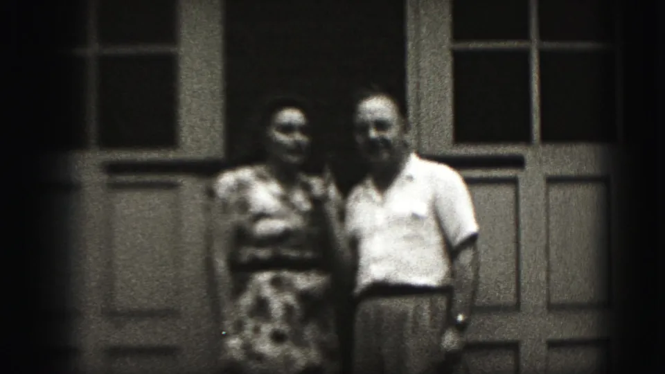The two adults face the camera together in the final frame of the metadata-supported 1975 Harrisburg 8mm clip.