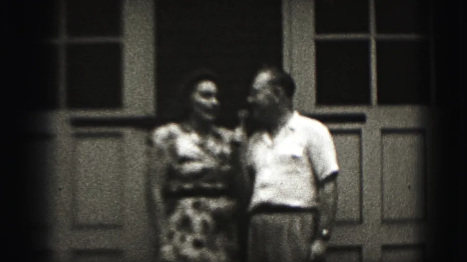 The closing frame keeps the adult couple on the Harrisburg porch, still facing each other in a brief 1975 family-film moment.