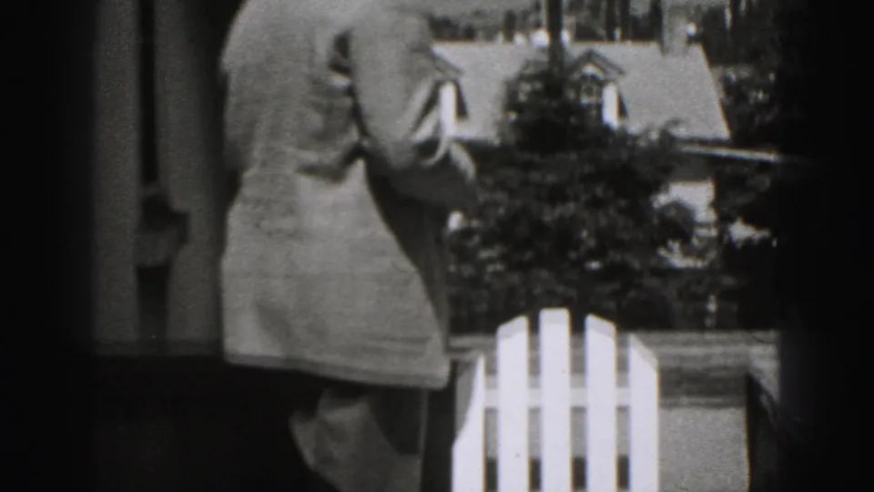 The final frame shows the man from behind near the white chair, with shrubs and a residential exterior visible in the background.