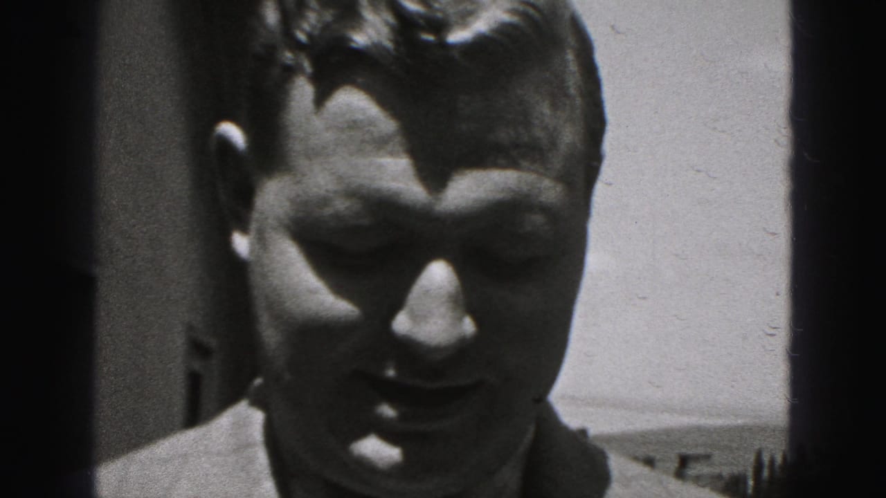 Close-up of a man outdoors, partly shadowed, facing the camera.