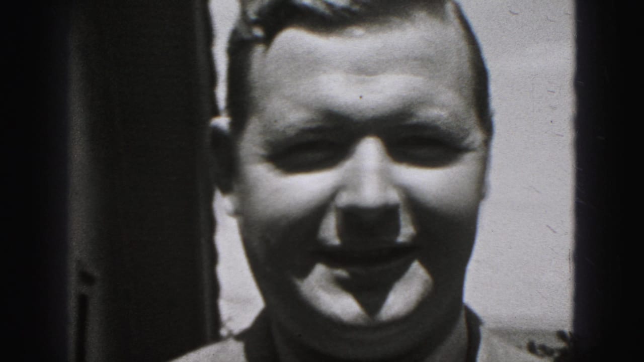 Smiling man in close-up outdoors with bright light behind him.