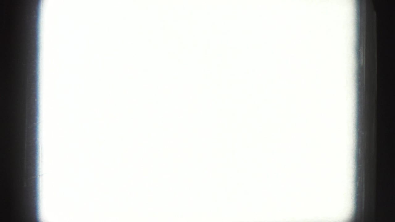 Overexposed 8mm frame with only dark gate edges visible, suggesting an in-camera exposure or framing adjustment.
