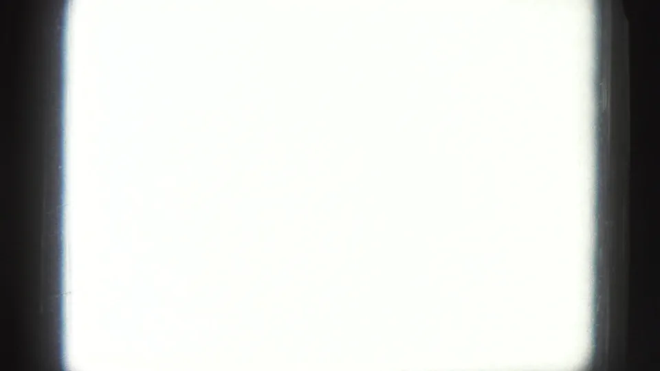 Overexposed 8mm frame with only dark gate edges visible, suggesting an in-camera exposure or framing adjustment.