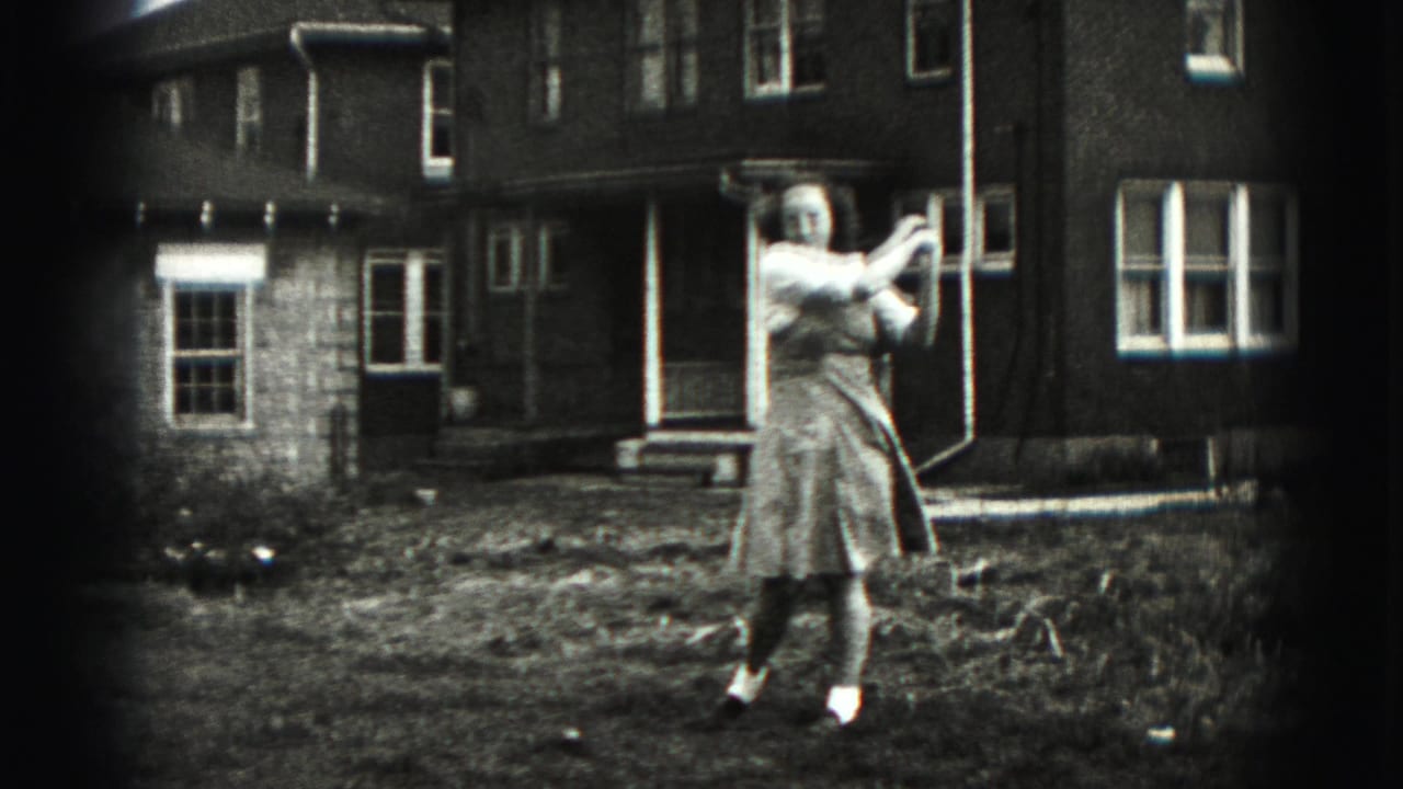 Woman in a light dress holds a golf club in a backyard near a brick house.