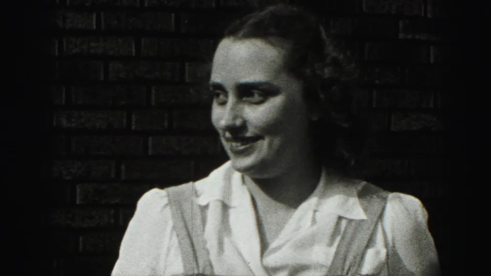 The woman shifts her gaze and smile slightly to one side in the 1975 Harrisburg 8mm home-movie shot.