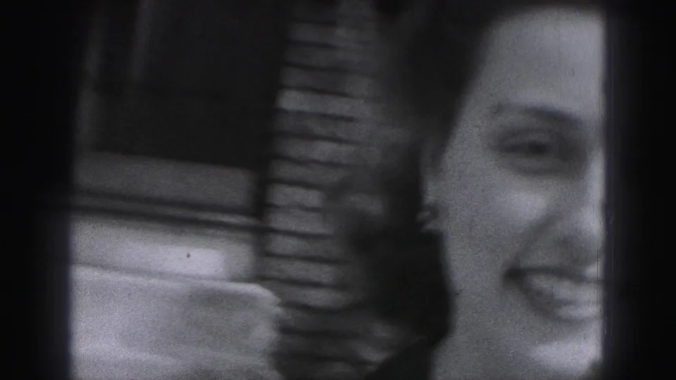 A tight home-movie close-up shows the woman laughing or smiling as she nears the camera outside in Harrisburg.