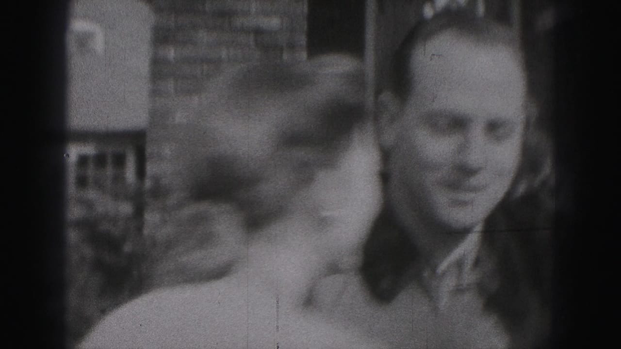 Three adults appear together outside in Harrisburg, with a man in military-style uniform beside two women.