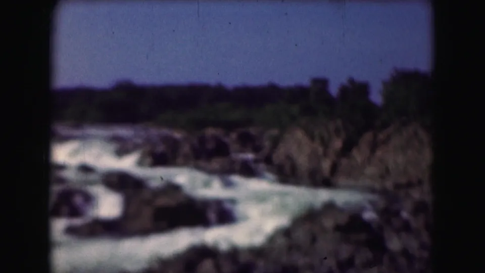 1975 8mm frame of whitewater moving through a rocky river scene in the Washington, DC metadata location.