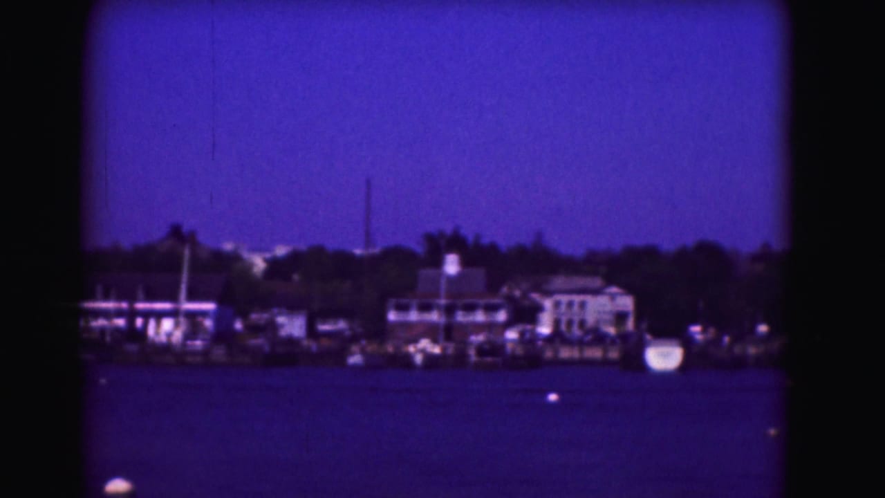 1975 8mm view likely in Washington, DC, showing a distant shoreline with buildings and trees across blue water.