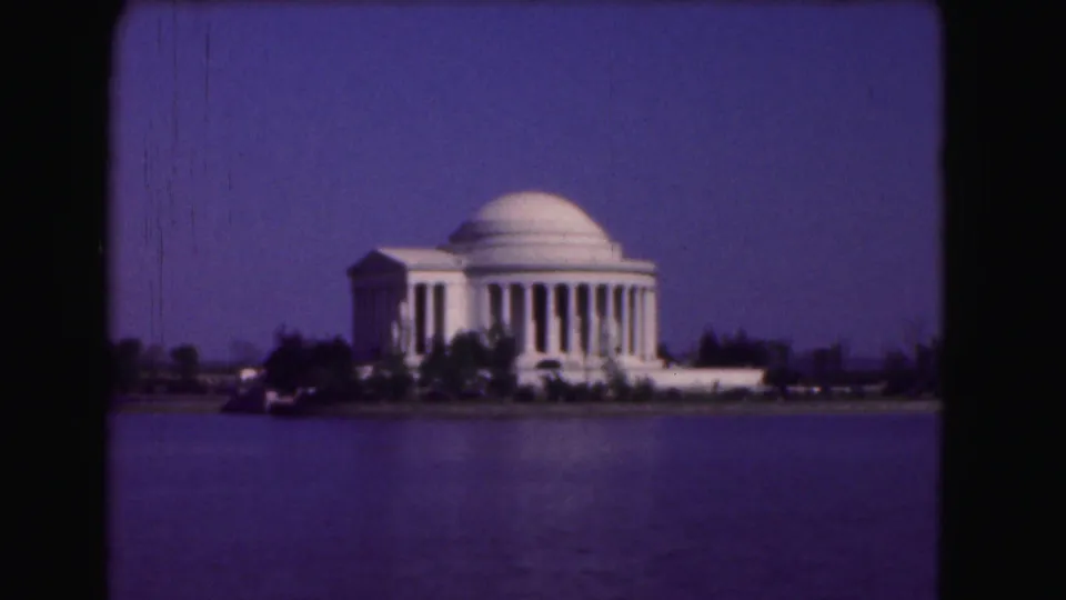 1975 Washington DC 8mm frame showing the Jefferson Memorial across the Tidal Basin with visible film gate borders.
